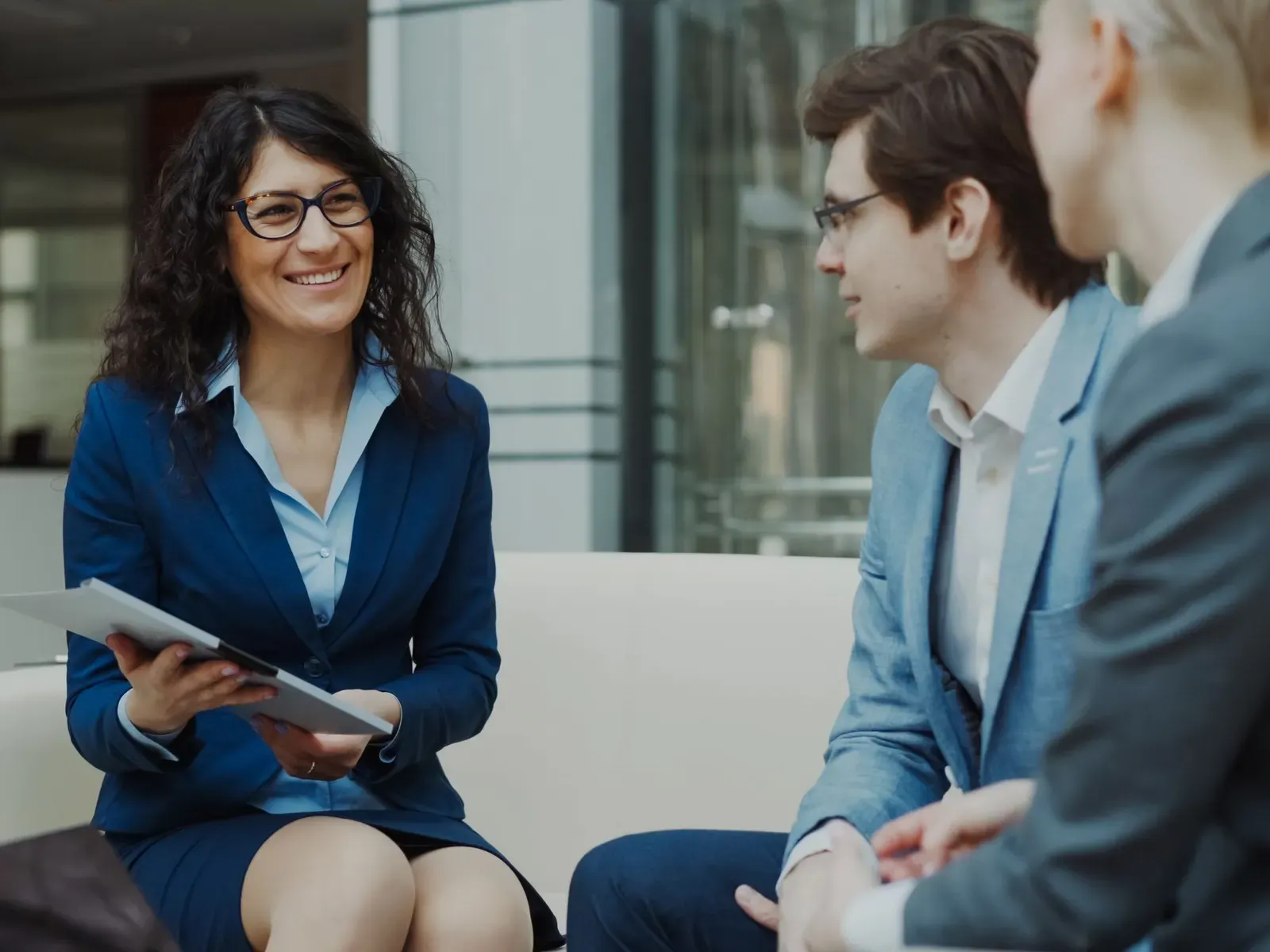 A relaxed conversation between colleagues in a bright office lounge