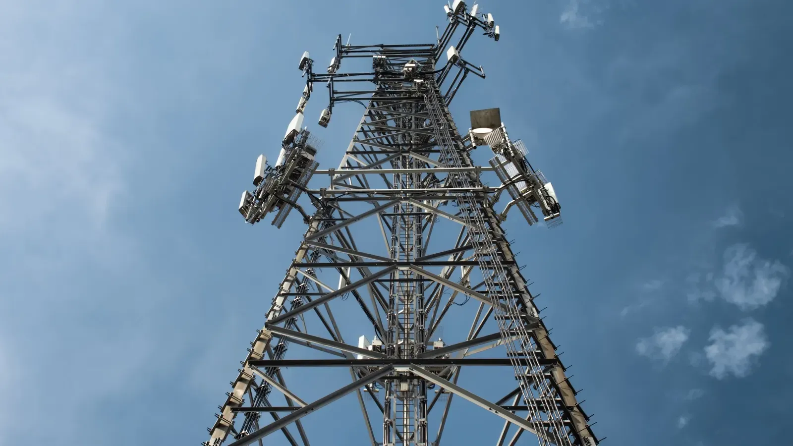 A telecommunications tower against a blue sky