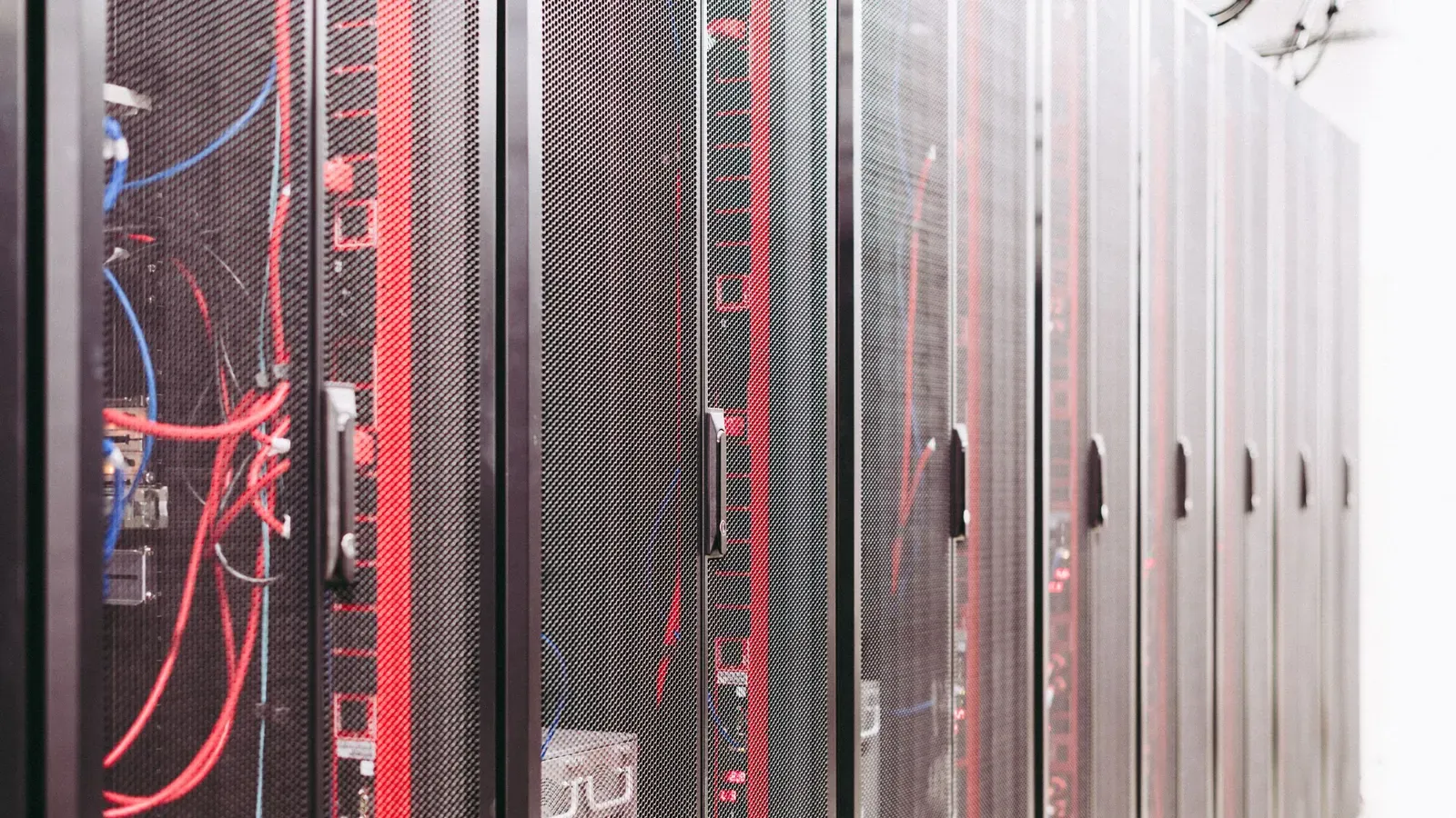 Server racks with red network cabling